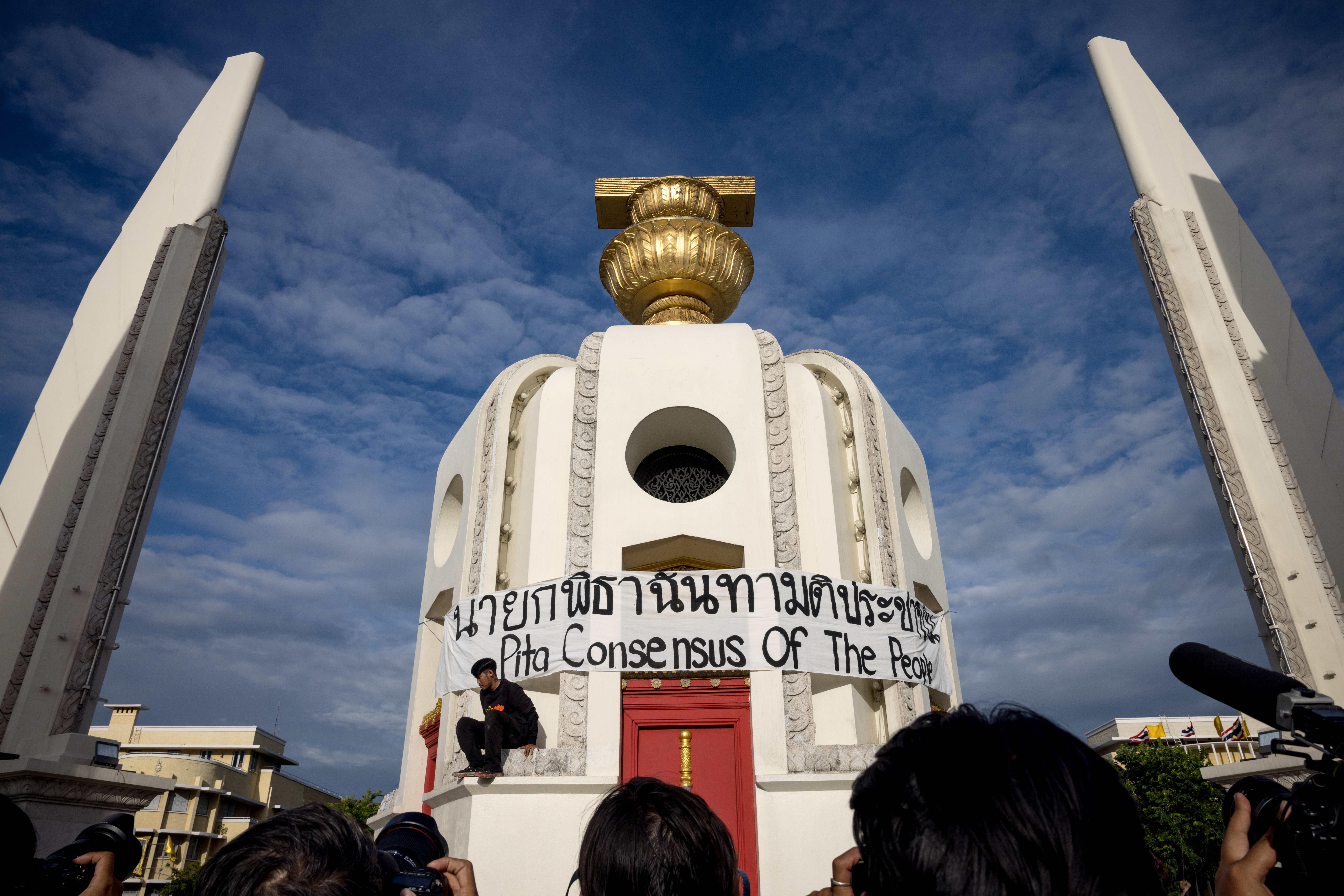 A banner is wrapped around the Democracy Monument during a protest following the suspension of Move Forward Party leader and prime ministerial candidate Pita Limjaroenrat in Bangkok on July 19, 2023. - Thailand's constitutional court suspended reformist Pita Limjaroenrat on July 19, in another blow to his hopes of becoming the nation's next leader after a stunning election win. Photo by Jack Taylor/AFP